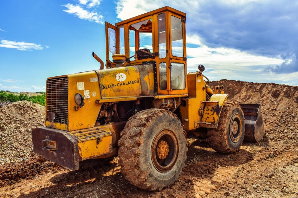 A yellow bulldozer on a construction site, highlighting heavy machinery in action.