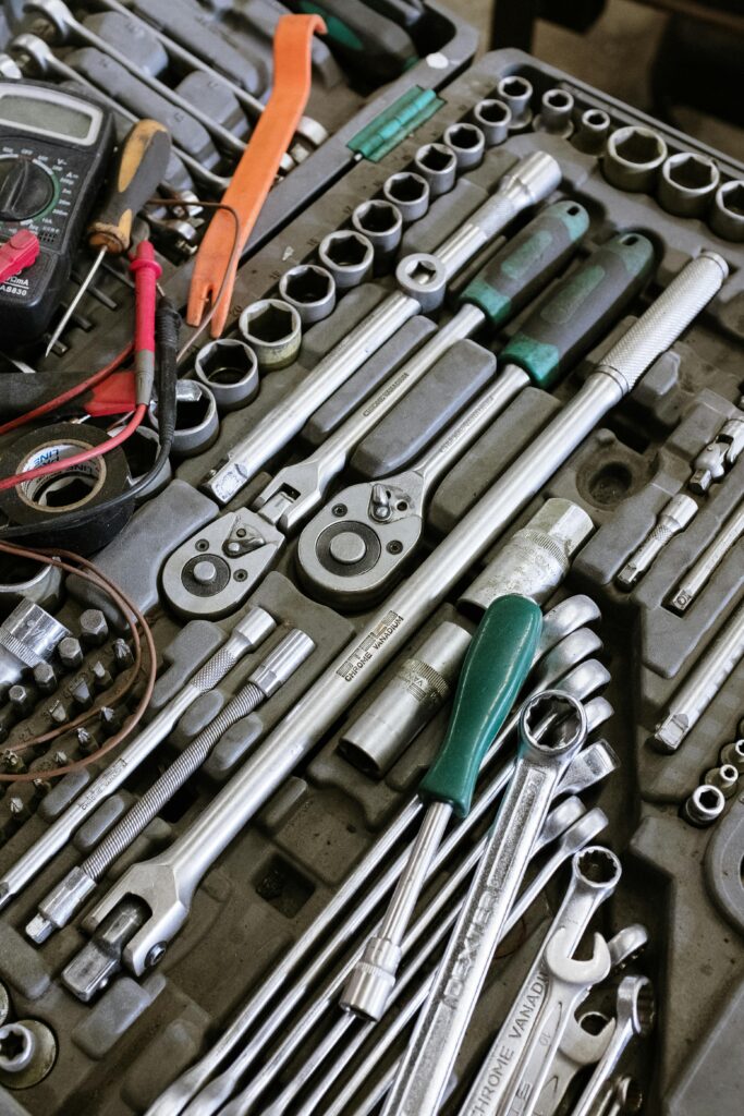 Detailed photo of various mechanic tools organized in a workshop setting. Perfect for repair themes.